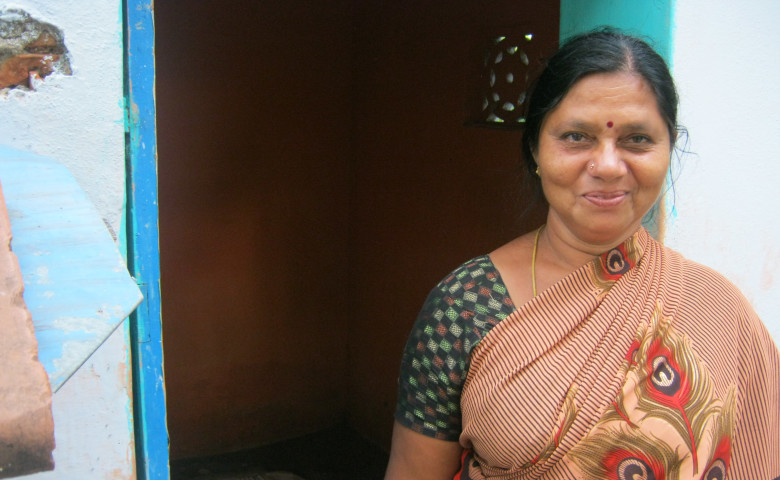 Shantha standing in front of her toilet