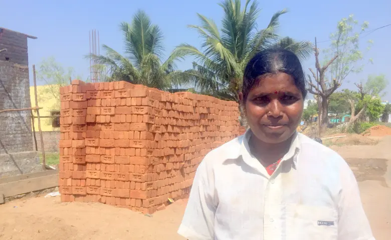 Mohanambal stands in front of her work site