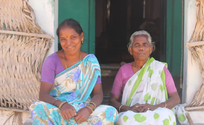Radhika and her aunt outside their new house